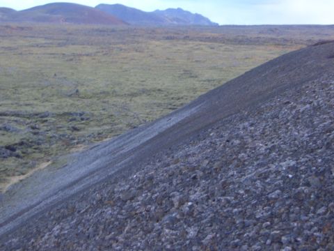 1974 Ford Bronco - A vast, barren landscape with rolling hills and mountains under a cloudy sky.