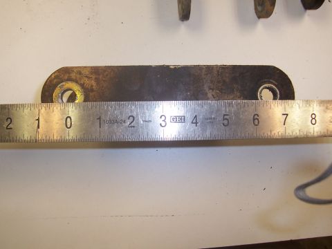 1979 Ford Bronco - A metal bracket is shown with a ruler indicating its dimensions.