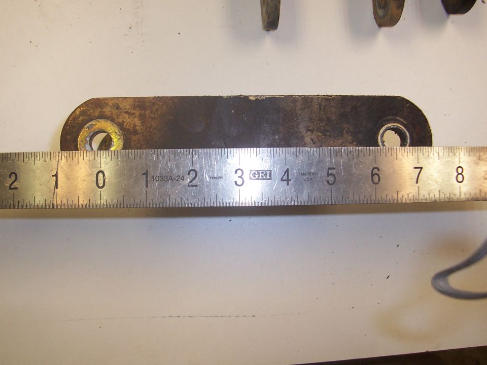 metal bracket being measured by a ruler