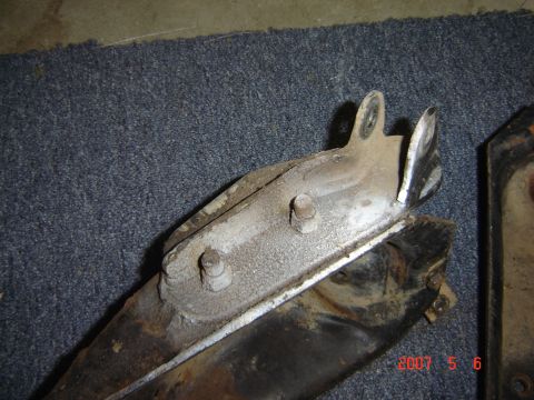 1993 Ford Bronco - Close-up of a corroded metal bracket, likely a vehicle suspension component.