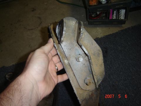 1993 Ford Bronco - A metal bracket, likely a vehicle part, is examined closely.