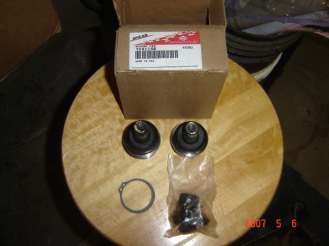 1993 Ford Bronco - A Spicer ball joint kit, part number 706116X, is displayed on a wooden surface next to its box.