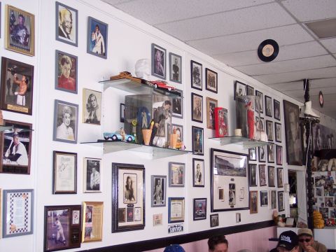 1972 Ford Ranchero - A wall displays a collection of framed pictures and various decorative items.