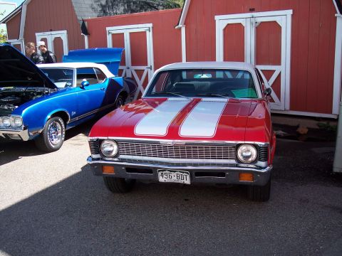 1972 Ford Ranchero - 1970 Chevrolet Nova parked next to a blue convertible in front of red barns.