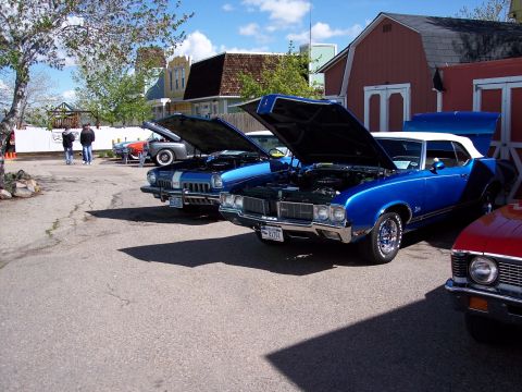 1972 Ford Ranchero - Several vintage automobiles are displayed with their engines exposed on a sunny day.