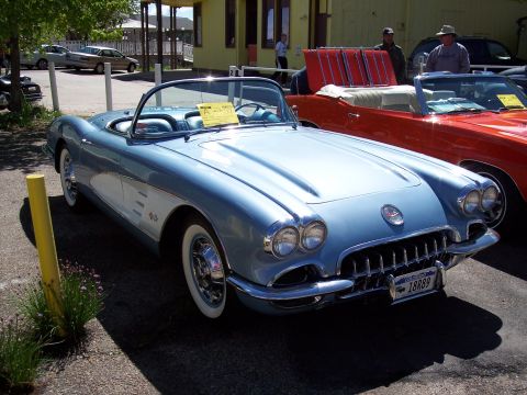 1972 Ford Ranchero - This light blue 1958 Chevrolet Corvette has a white cove and is parked next to another convertible.