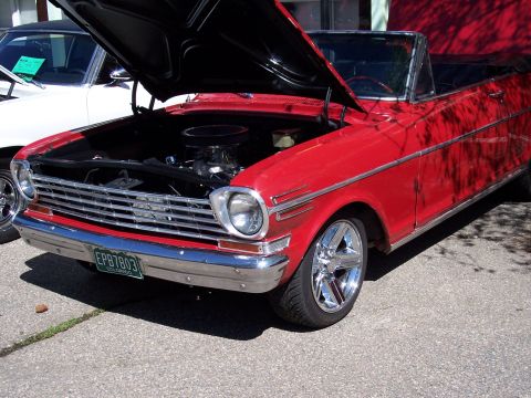 1972 Ford Ranchero - A red convertible with its hood open sits next to another vehicle, displaying custom wheels and a Colorado license plate.