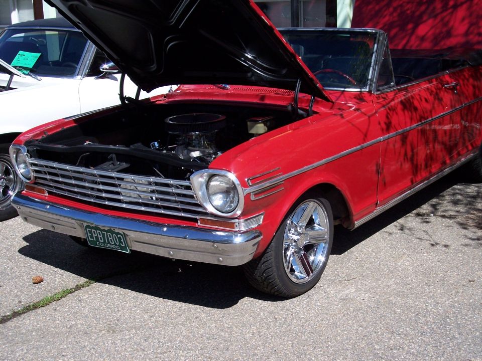 Red convertible with hood open, chrome grille, and custom wheels. Colorado license plate EPB7803 visible