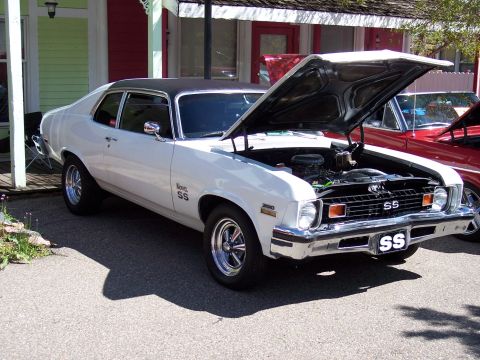 1972 Ford Ranchero - White 1972 Chevrolet Nova SS, hood up, parked outdoors with another vehicle nearby.