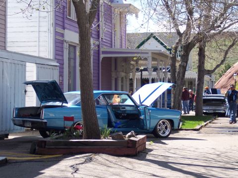 1972 Ford Ranchero - A blue 1966 Chevrolet Nova coupe is parked on a street with its hood and trunk open.
