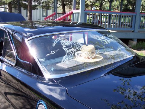 1972 Ford Ranchero - A black car's rear window features a grim reaper decal and a straw hat, with the text 'Fear the Reaper' visible.