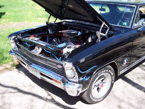 1972 Ford Ranchero - Black 1967 Nova with hood open, revealing the engine. Features custom wheels and racing tires.