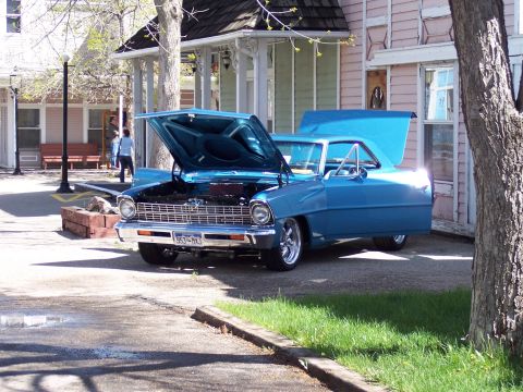 1972 Ford Ranchero - A blue 1966 Chevrolet Nova coupe is parked with its hood and trunk open, showing off its engine.