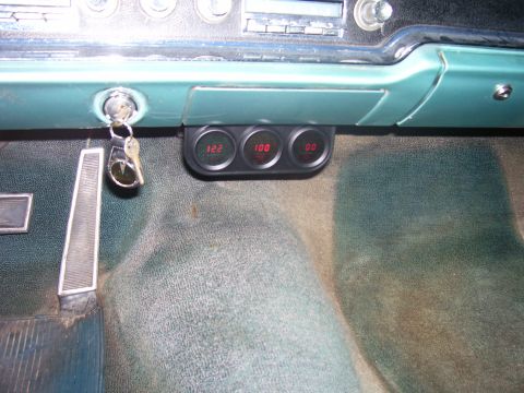 1965 Pontiac Catalina - Aftermarket gauges installed in a car's dashboard, with keys in the ignition.