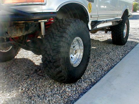 1996 Ford Bronco - This modified Ford Bronco features oversized tires and a custom bumper, suggesting a model year earlier than claimed.