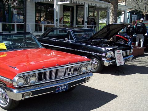 1972 Ford Ranchero - Two classic cars, a red Ford and a black 1963 Nova, are displayed outdoors.