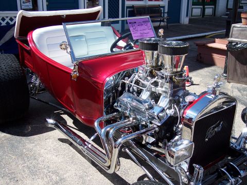 1972 Ford Ranchero - A custom hot rod with a powerful engine and shiny chrome details sits on display.