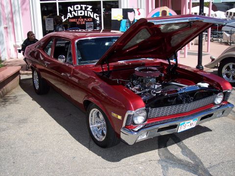 1972 Ford Ranchero - This red coupe has its hood open, revealing the engine and chrome details.