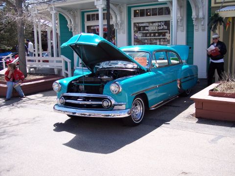1972 Ford Ranchero - A classic turquoise sedan is displayed with its hood and trunk open, parked on a sunny day.