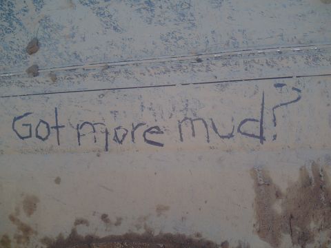 1991 Ford Bronco - The side of a vehicle is covered in mud with the question "Got more mud?" scrawled on it.