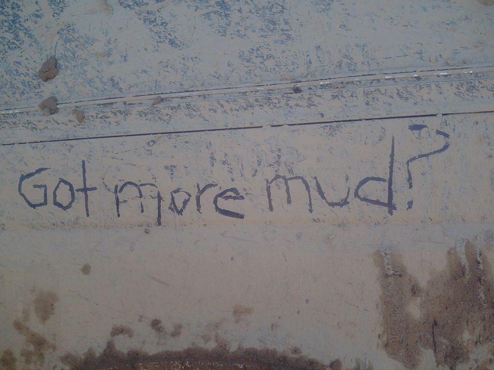 Muddy vehicle side with "Got more mud?" written on it
