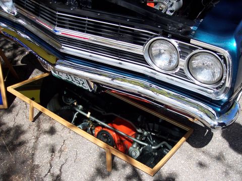1972 Ford Ranchero - A blue 1964 Chevrolet Chevelle's front end is displayed with its hood open and engine reflected in a mirror placed beneath it.