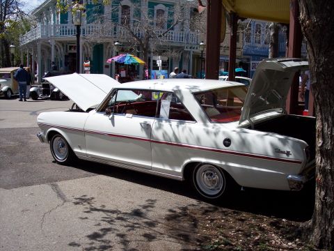 1972 Ford Ranchero - White coupe with red interior, hood and trunk open. The "Nova" badge is visible on the rear quarter panel.