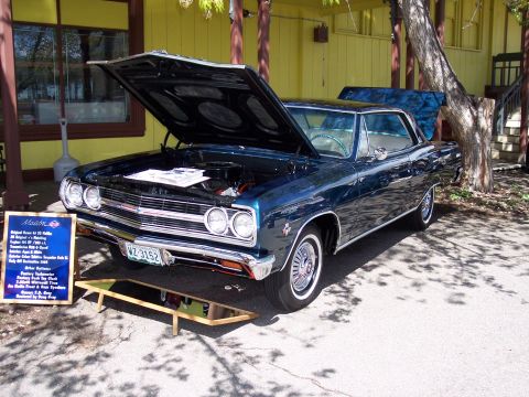1972 Ford Ranchero - 1965 Chevrolet Chevelle Malibu coupe on display with its hood and trunk open.