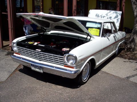 1972 Ford Ranchero - A white 1960s Chevrolet Nova is displayed with its hood open, revealing the engine compartment.