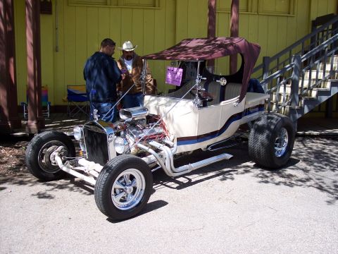 1972 Ford Ranchero - Custom T-bucket hot rod with a powerful engine and unique canopy is on display.