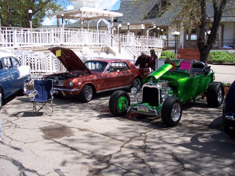 1972 Ford Ranchero - Several classic vehicles are displayed outdoors, with two cars having their hoods open.