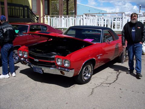 1972 Ford Ranchero - A red El Camino with its hood open stands next to another red car, with a man standing nearby.