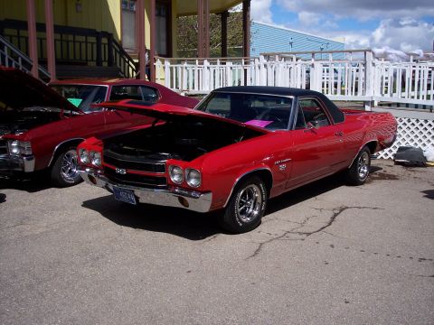 1972 Ford Ranchero - Two red Chevrolet El Caminos from the early 1970s are displayed with their hoods open.
