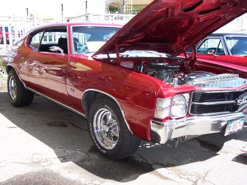 1972 Ford Ranchero - A classic red Chevrolet Chevelle SS is displayed with its hood up, revealing the engine bay.