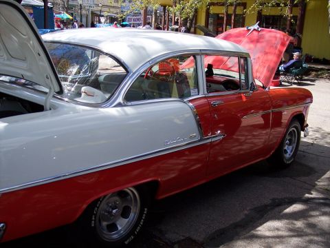 1972 Ford Ranchero - This classic two-tone red and white coupe, identified as a 1955 Chevrolet Bel Air, is displayed with both hoods open.