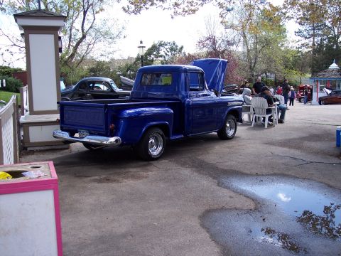 1972 Ford Ranchero - A blue 1955 Chevrolet pickup truck is displayed with its hood open at an outdoor event.