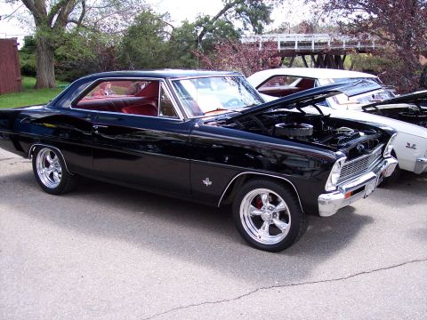1972 Ford Ranchero - Two classic cars parked side-by-side, one with its hood open, under a bridge structure.