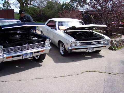 1972 Ford Ranchero - Two vintage cars, a white Chevelle SS and a black car, are parked side-by-side with their hoods open.