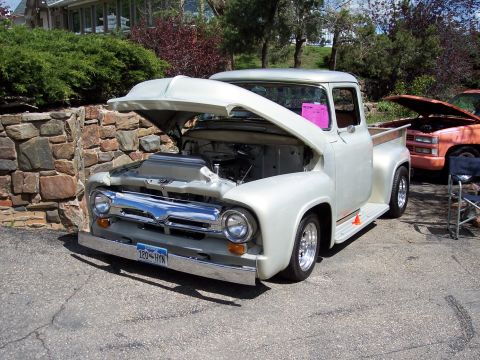 1972 Ford Ranchero - Silver 1956 Ford F-100 pickup truck with its hood open, parked outdoors.