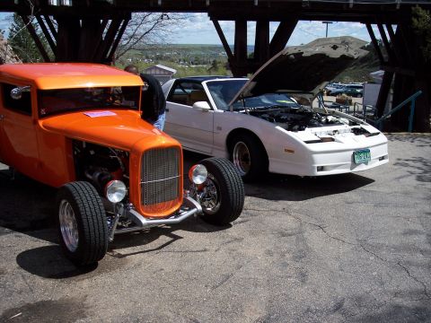 1972 Ford Ranchero - Two cars are parked side-by-side under a bridge structure.