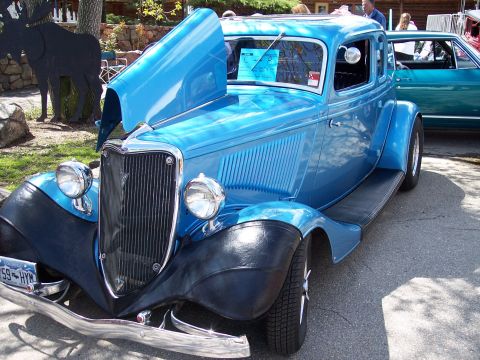 1972 Ford Ranchero - A blue 1934 Ford coupe is displayed with its hood open, parked outdoors.