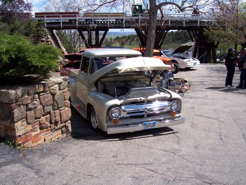 1972 Ford Ranchero - This 1956 Ford F-series pickup truck has its hood open, parked outdoors with other vehicles present.
