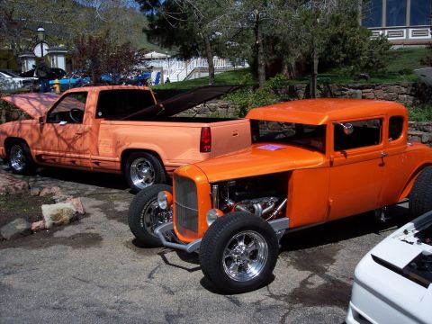 1972 Ford Ranchero - Two custom vehicles, an orange coupe and a peach pickup, are parked outdoors on a sunny day.