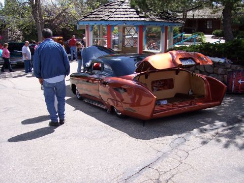 1972 Ford Ranchero - A customized classic car is displayed with its trunk open, parked next to another vehicle.