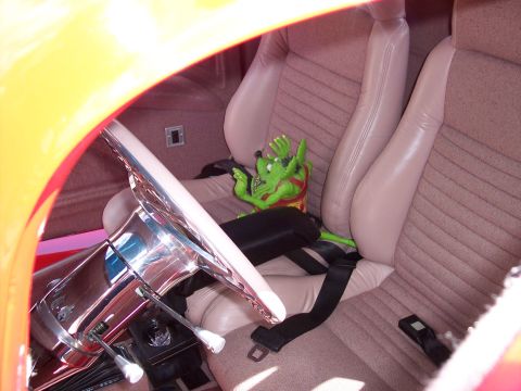 1972 Ford Ranchero - Interior view of a car with beige seats and a green toy figure in the passenger seat.