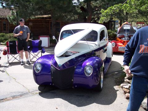 1972 Ford Ranchero - A custom hot rod is displayed outdoors with its hood up, while another vehicle is visible behind it.