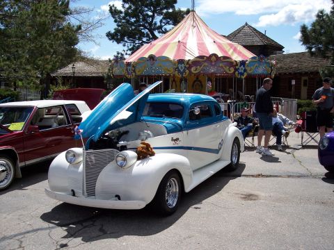 1972 Ford Ranchero - A classic two-tone coupe is displayed with its hood open at an outdoor event.