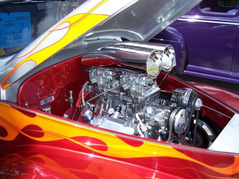 1972 Ford Ranchero - Custom engine bay with chrome details and flame graphics, parked next to a purple car.