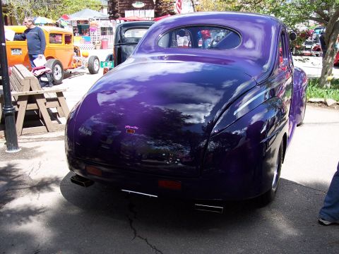 1972 Ford Ranchero - A shiny purple coupe is parked outdoors, reflecting the sky and trees.