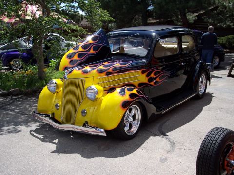 1972 Ford Ranchero - Custom hot rod with flame graphics and a yellow front end sits outside.